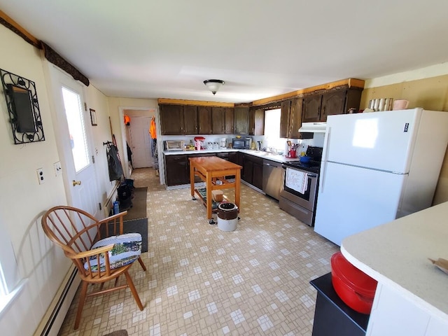 kitchen featuring dark brown cabinets, stainless steel appliances, light tile patterned floors, and a baseboard heating unit