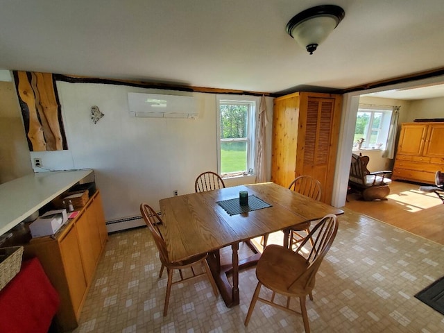 dining space with an AC wall unit, a wealth of natural light, light hardwood / wood-style flooring, and a baseboard heating unit