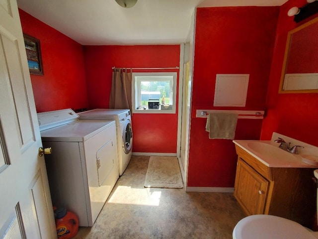 laundry room with separate washer and dryer and sink