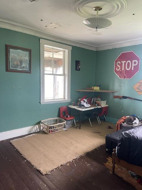 bedroom featuring hardwood / wood-style floors and crown molding