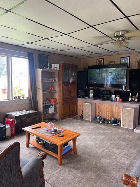 living room with carpet floors and ceiling fan