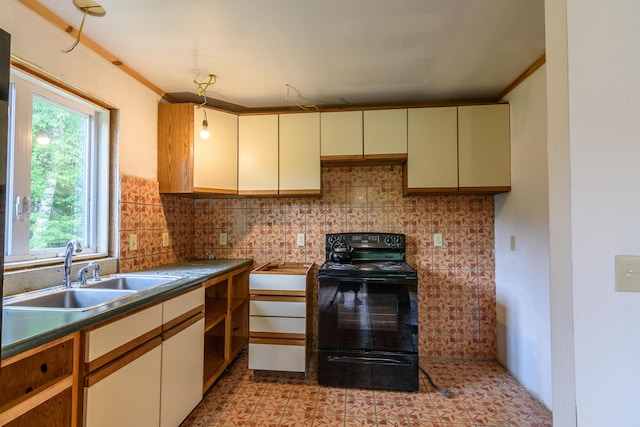 kitchen featuring tasteful backsplash, ornamental molding, sink, cream cabinetry, and black / electric stove