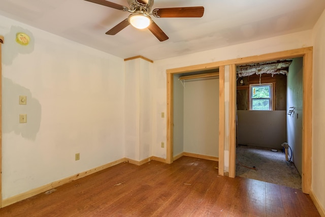 unfurnished bedroom with ceiling fan, a closet, and hardwood / wood-style flooring