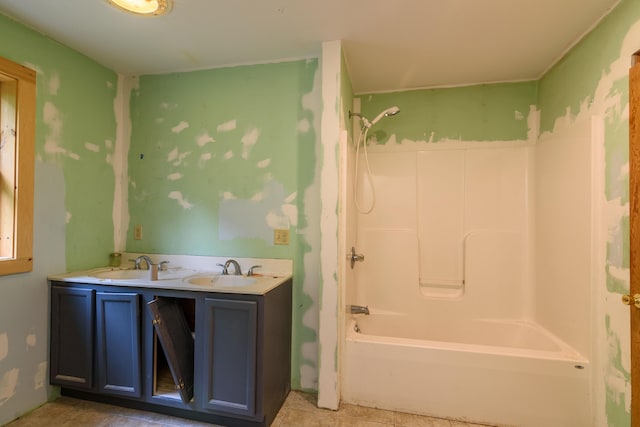 bathroom featuring vanity and  shower combination