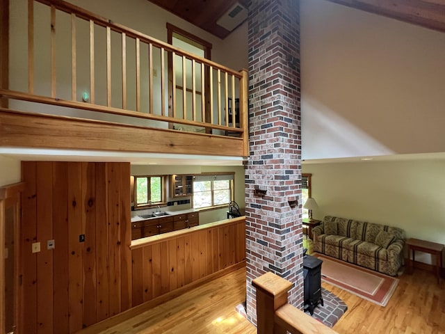 937 N Rd, Bethel, ME 04217 - interior space featuring light wood-style floors, decorative columns, and a wood stove