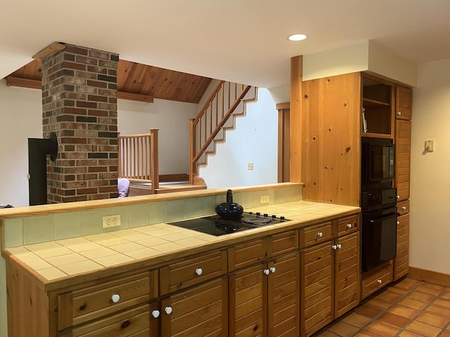 937 N Rd, Bethel, ME 04217 - kitchen with tile counters, black appliances, recessed lighting, tile patterned floors, and brown cabinetry