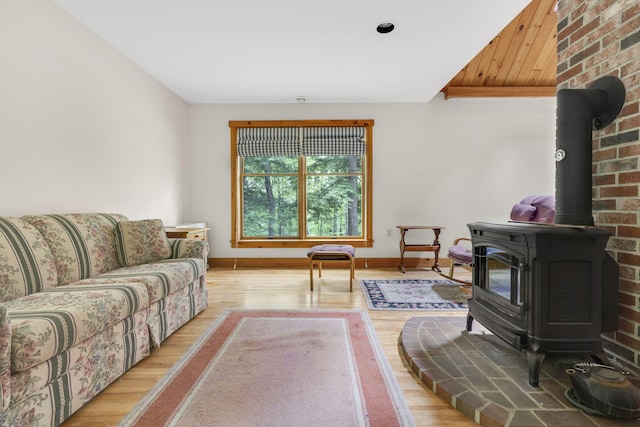 living room featuring light wood-type flooring and a wood stove