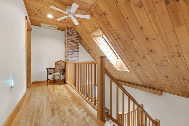 bonus room featuring ceiling fan, wood ceiling, lofted ceiling with skylight, and light wood-type flooring