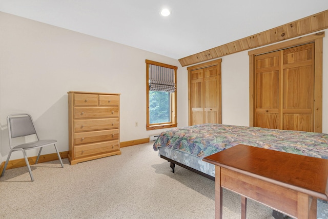 carpeted bedroom with lofted ceiling