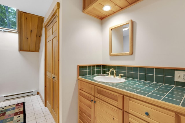 bathroom featuring vanity, wooden ceiling, tile patterned flooring, baseboard heating, and tasteful backsplash