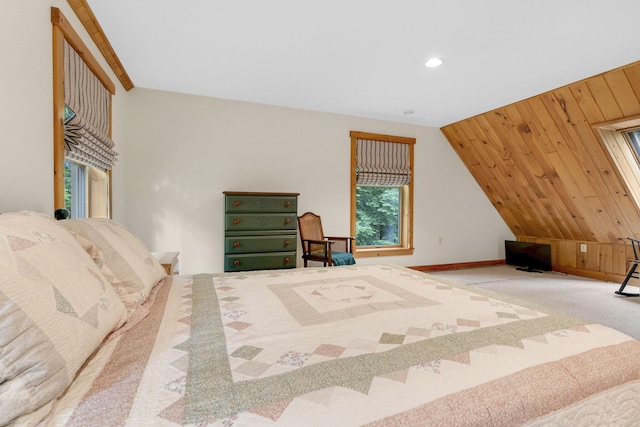 bedroom featuring carpet flooring, vaulted ceiling, and wooden walls