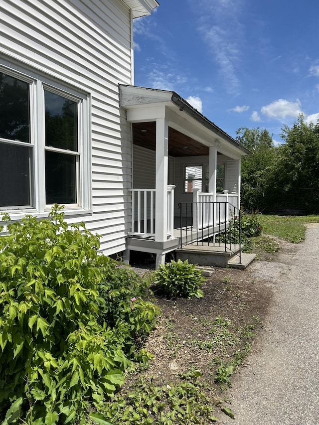 view of side of property with covered porch