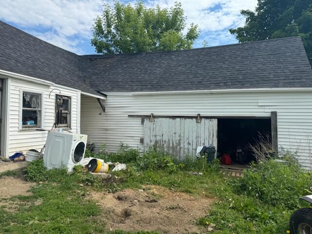 exterior space featuring ac unit and a garage