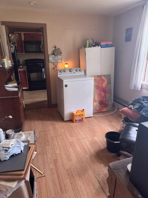 washroom featuring washer / clothes dryer and light hardwood / wood-style floors