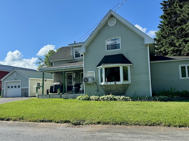 view of front property featuring a front yard, covered porch, and a garage