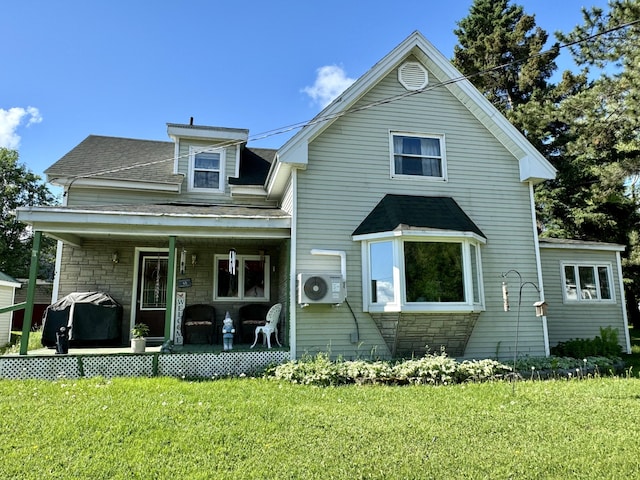 view of front facade with a front lawn, ac unit, and covered porch