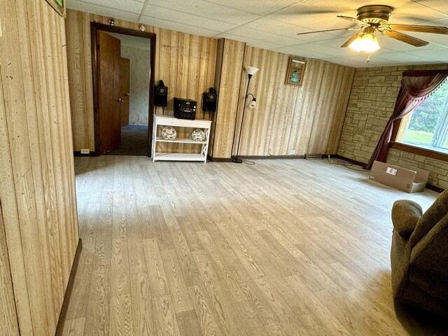 unfurnished living room featuring ceiling fan, hardwood / wood-style floors, and a paneled ceiling