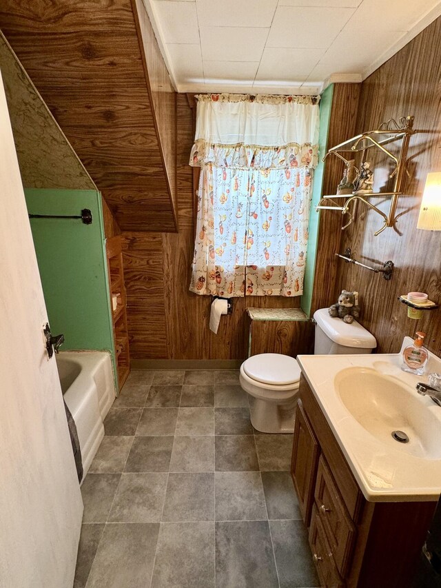 bathroom with toilet, a washtub, wooden walls, and vanity