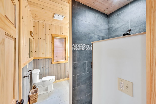 bathroom featuring wooden ceiling, toilet, tile patterned flooring, and wood walls