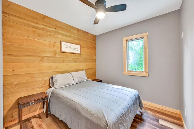 bedroom with ceiling fan and hardwood / wood-style flooring