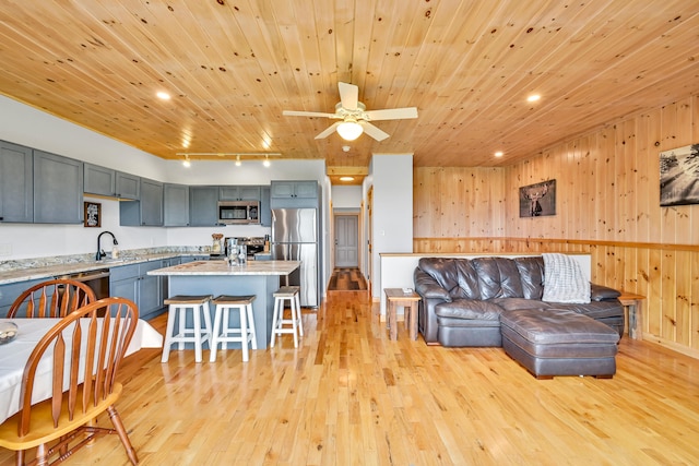 living room with ceiling fan, light wood-type flooring, wooden ceiling, sink, and rail lighting