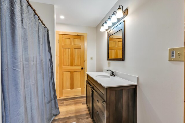 bathroom with hardwood / wood-style flooring and vanity