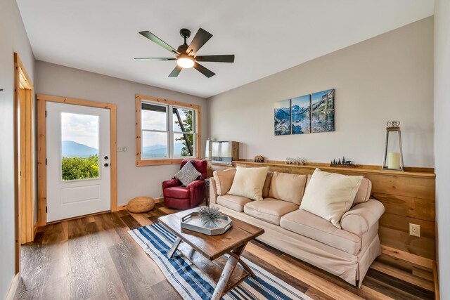 living room with ceiling fan and dark hardwood / wood-style floors