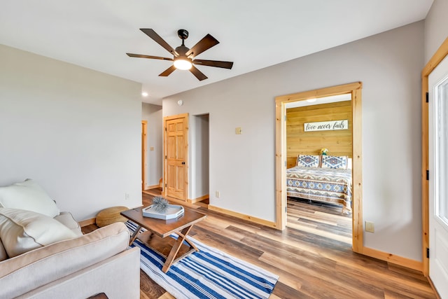 living room featuring ceiling fan and wood-type flooring