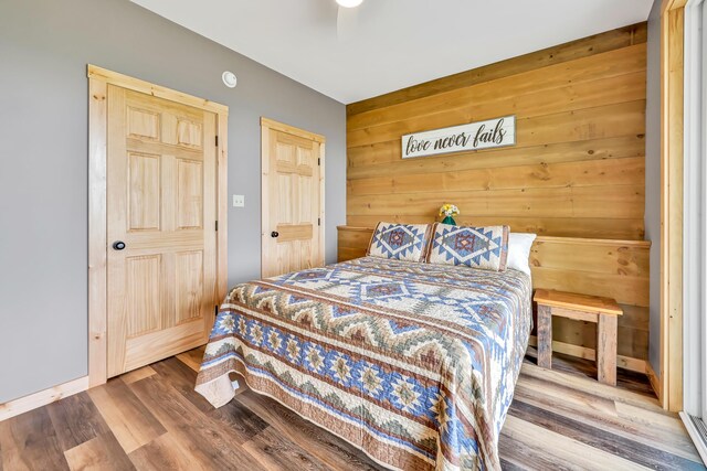 bedroom with hardwood / wood-style flooring and ceiling fan