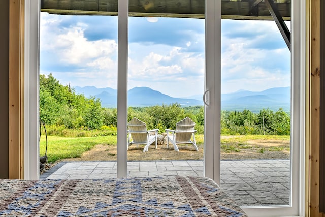 doorway to outside with a mountain view and a healthy amount of sunlight