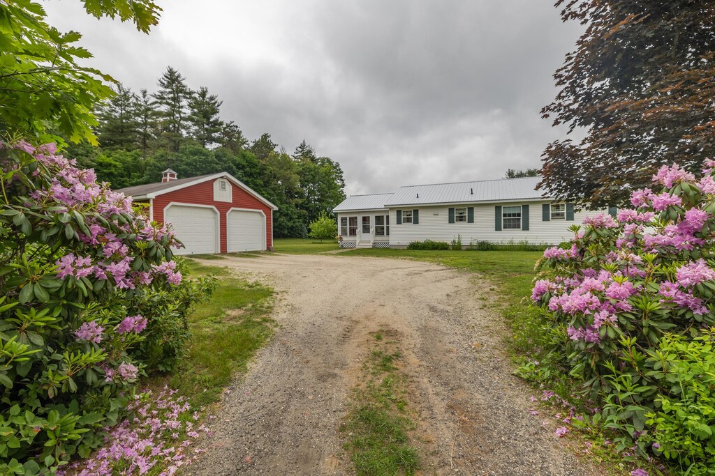 2925 Turner Rd, Auburn, ME 04210 - view of front of home with driveway, an outbuilding, a garage, and a front yard
