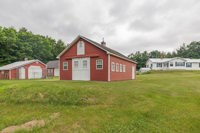 view of outbuilding with a yard