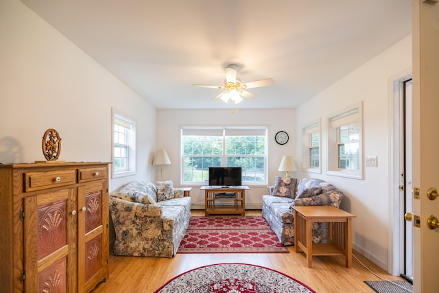 living room with ceiling fan, a wealth of natural light, and light hardwood / wood-style flooring