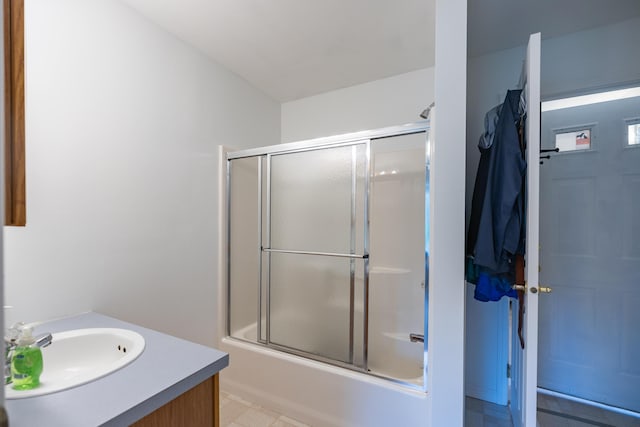 bathroom featuring vanity and enclosed tub / shower combo