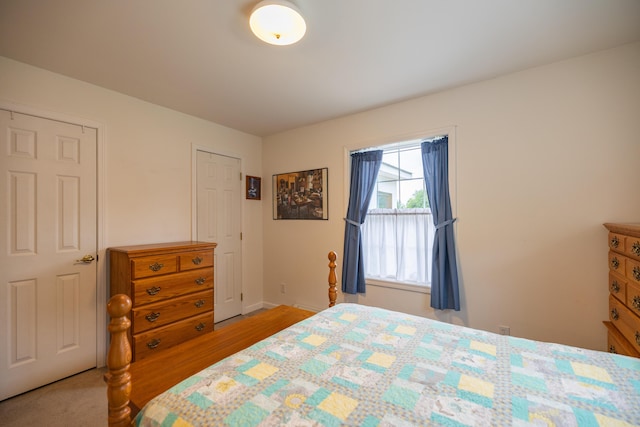 bedroom featuring light carpet and a closet