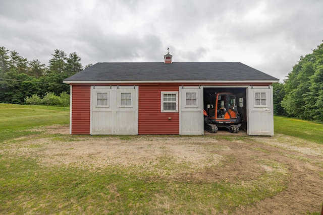 view of outbuilding with a yard