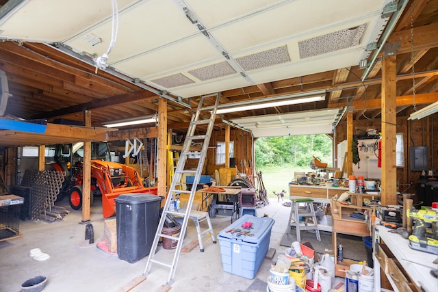 garage with a workshop area and electric panel