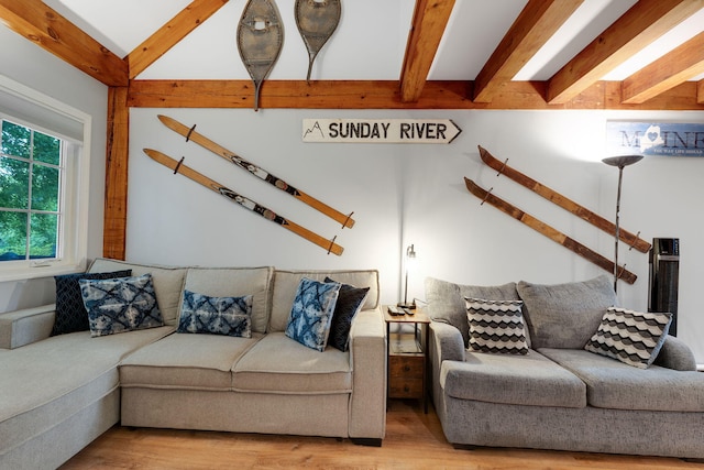 living room featuring beam ceiling and light wood-type flooring