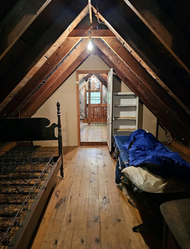 bedroom featuring hardwood / wood-style flooring and vaulted ceiling