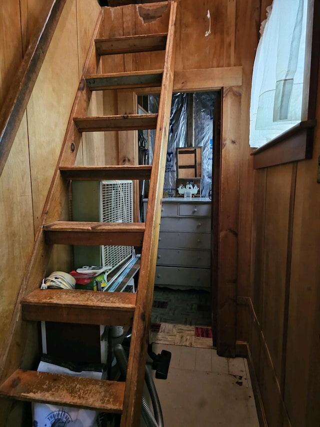 stairway with wood walls