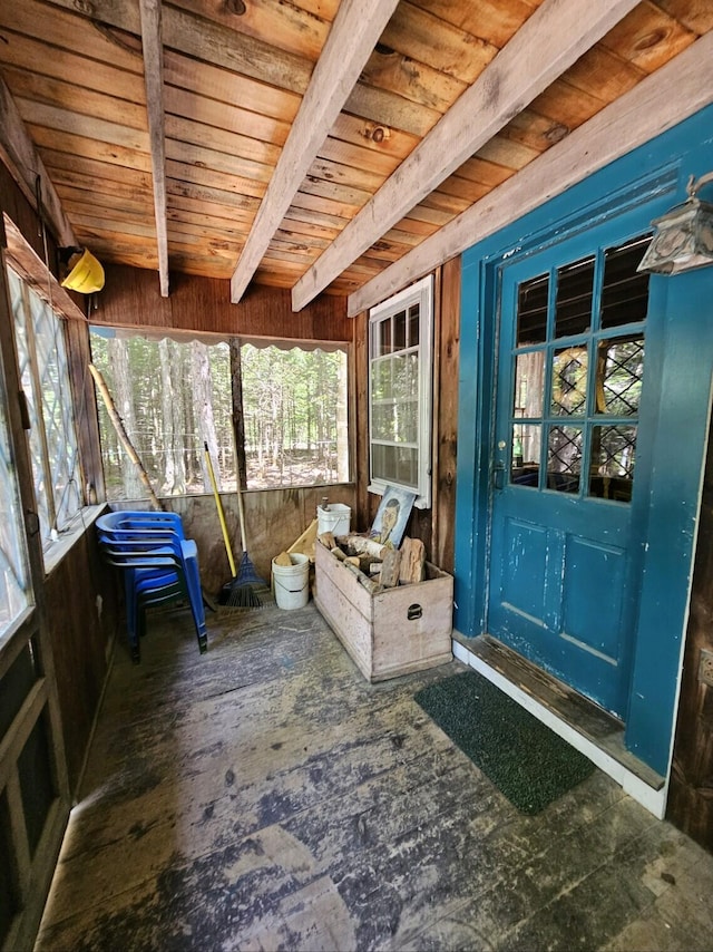 sunroom / solarium featuring beamed ceiling and wooden ceiling