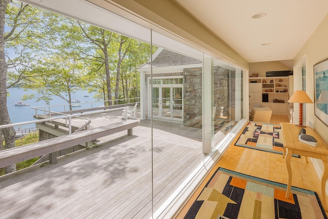 wooden terrace featuring a water view