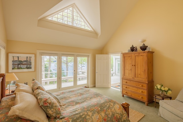 bedroom featuring carpet flooring, multiple windows, high vaulted ceiling, and access to exterior