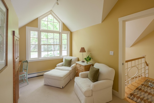 sitting room with a baseboard radiator, lofted ceiling, and light colored carpet