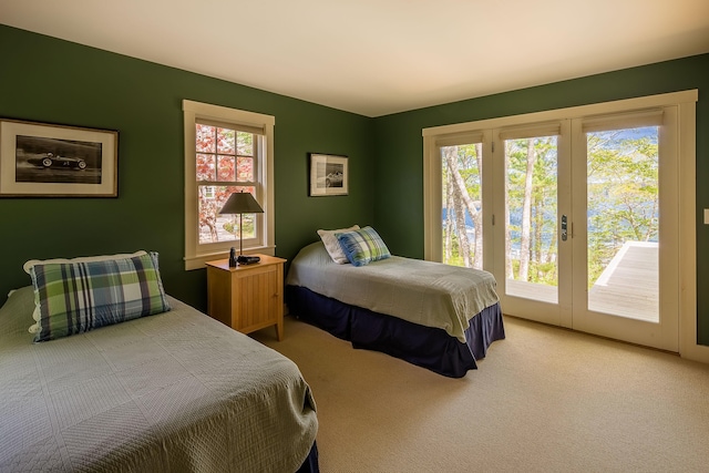 carpeted bedroom with access to outside and multiple windows