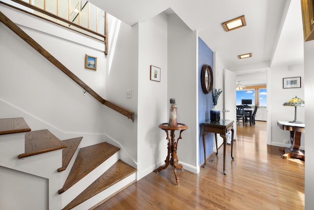 stairs featuring baseboards and wood finished floors