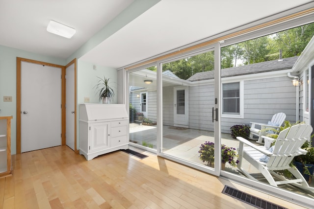 entryway with light wood-type flooring and visible vents