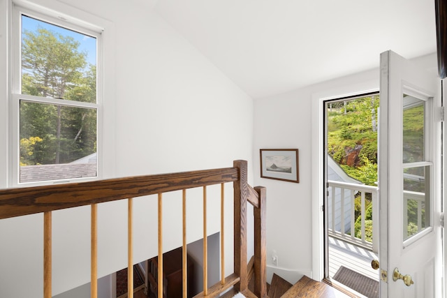 stairs with lofted ceiling and a wealth of natural light