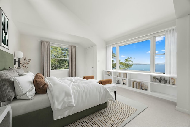 carpeted bedroom featuring vaulted ceiling and a water view