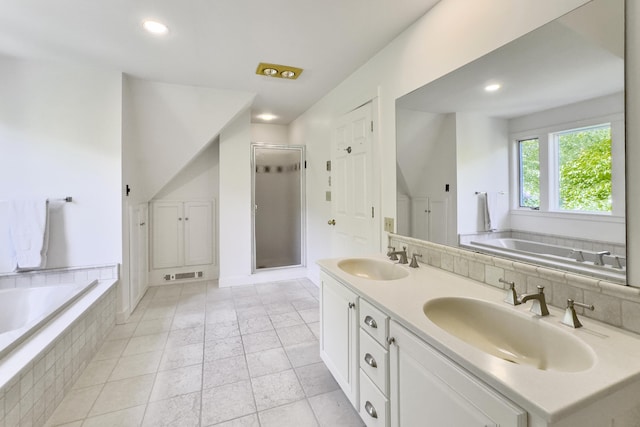 bathroom featuring tile patterned flooring, vanity, and plus walk in shower